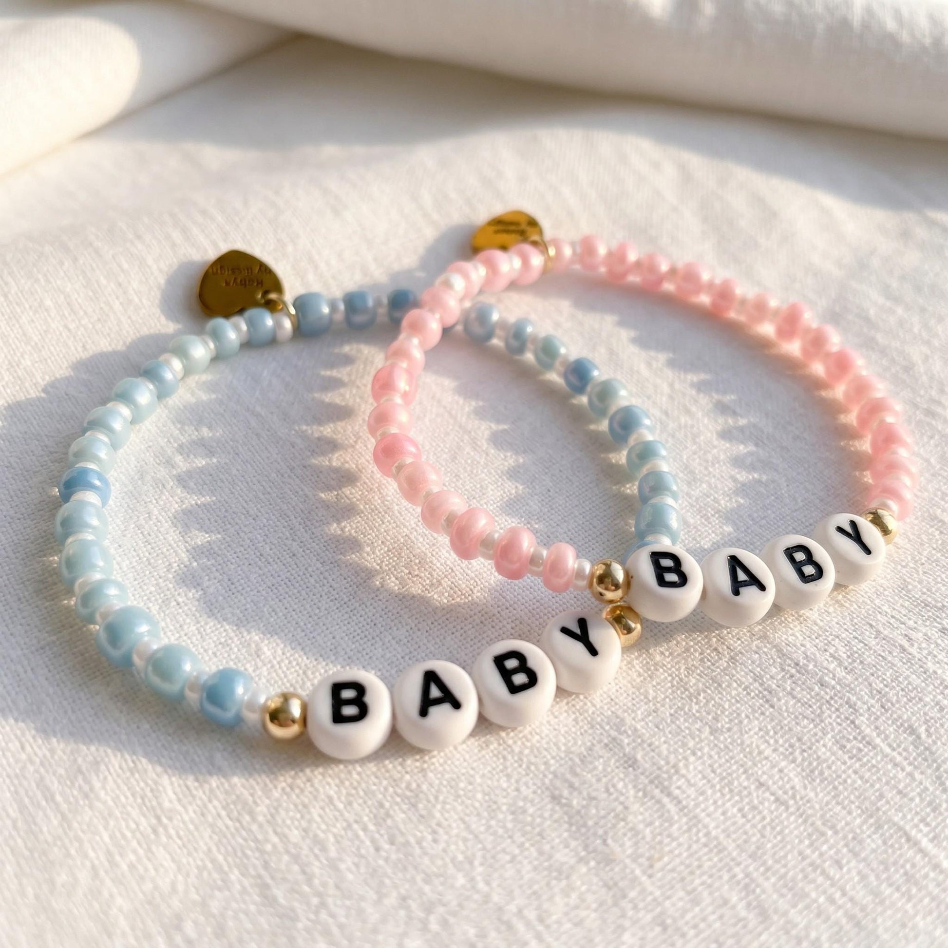 Personalized Baby Name Bracelet Custom Letter Beads Baby Shower Gift Gender Reveal Party Keepsake 14k Gold Filled Accents Stretch Band Design Black White Beads Pastel Pink Blue Options Pearlescent Finish Gold Heart Charm Big Sister Brother