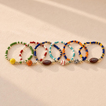 14k Gold Filled Sports Bracelet Customizable Team Jewelry Gift Multiple Sport Charm Options Football Basketball Soccer Baseball Tennis Cheer Megaphone Stretch Wristband Design Comfortable Athletic Accessory Perfect Sports Team Gift Youth
