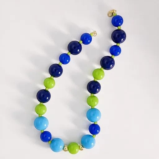Robyn by design statement necklace featuring polished navy, electric blue, sky blue, and lime green spherical beads.